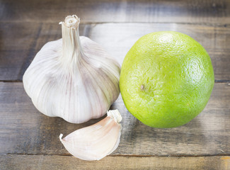 Garlic and lemon on the wooden background