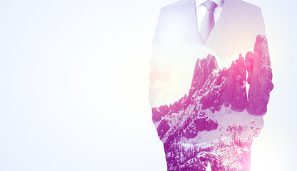 Businessman standing with mountain graphic