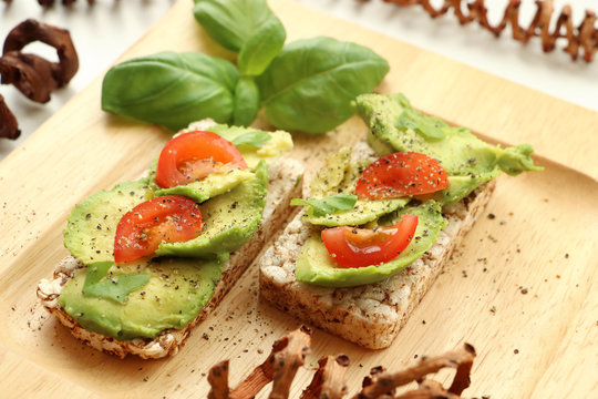Two sandwiches with avacado and basill