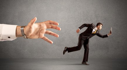 Businessman running from hand