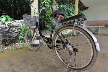 Fototapeta na wymiar Parked bicycle-shed at Tham Jang-Chang cave foot. Vang Vieng-Laos. 4732