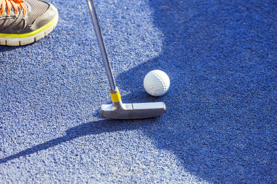 Closeup Of Putter And Ball On Mini Golf Course