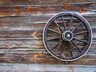 Old wooden wall with old wheel © Agnieszka