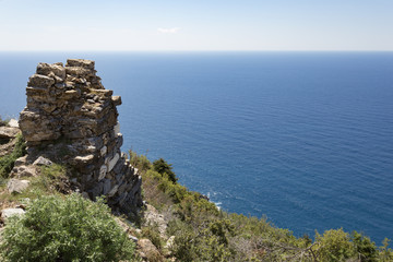 Ruins of ancient walls located uphill by sea