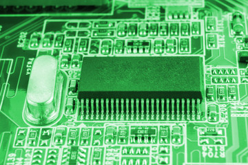 Chip on motherboard mainboard with controllers, ports and wires, close-up macro toned