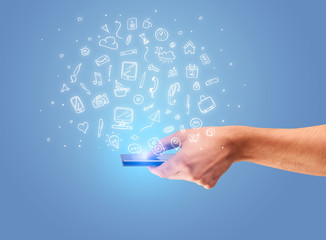 Hand with phone and drawn office icons