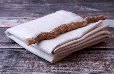 Miswak or Siwak With Sackcloth On Wooden Background.