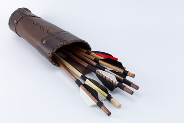 Different kinds of medieval handmade arrows with natural feathers in a handcrafted leather quiver...