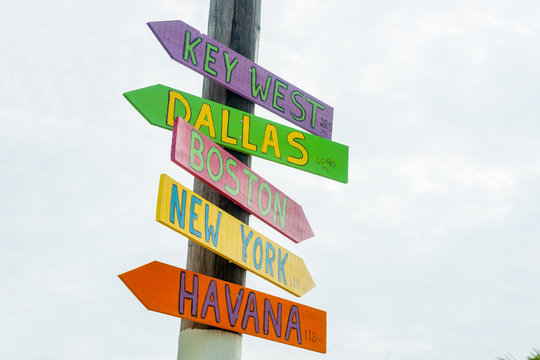 Colorful direction signs to major cities at Little Torch Key, Maimi