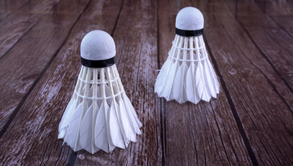 Shuttlecock on wooden background.