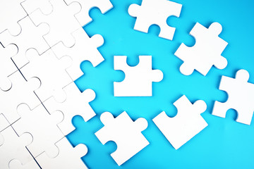 White jigsaw puzzle on blue background.