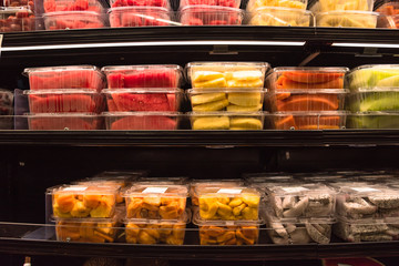 Fresh chopped, chunk fruit plastic box display in store at Houston, US. In-house cut, packed watermelon, pineapple, cantaloupe , jackfruit, pitaya (dragon fruit) to take away. Convenience and healthy