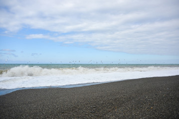 Waves on the pebble beach of the sea during a storm