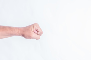 Closeup of right male hand raised up clenched fist