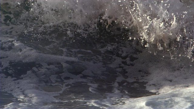 Ocean wave churning closeup in slow motion