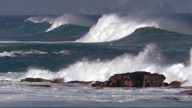Long shot of ocean waves in slow motion