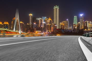 Fototapeta na wymiar City Empty Road,asphalt road through modern city at night in China.