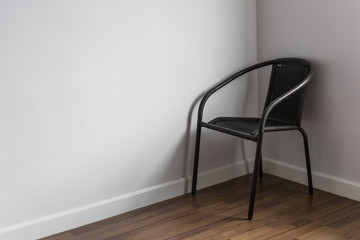 a chair stand alone in the corner of living room