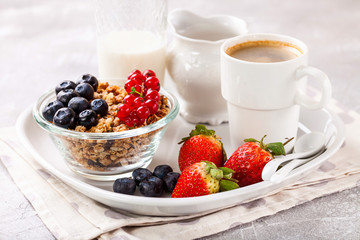 Breakfast - muesli, berries and coffee. Selective focus. Copy space