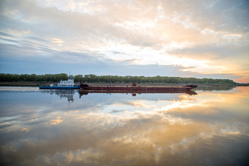 a barge on the river early in the morning