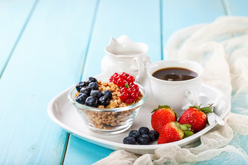 Breakfast - muesli, berries and coffee. Selective focus. Copy space