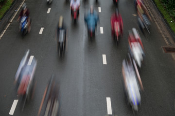 Blurred crowd of different people are walking in the city. Defocused background of city life
