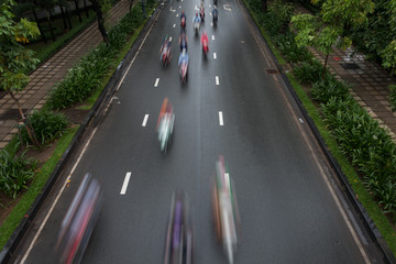 Blurred crowd of different people are walking in the city. Defocused background of city life