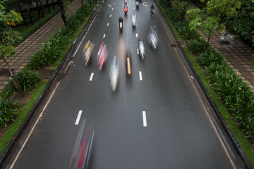 Blurred crowd of different people are walking in the city. Defocused background of city life