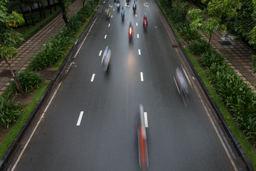 Blurred crowd of different people are walking in the city. Defocused background of city life
