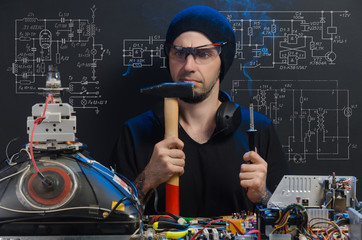 man is engaged in repair of electronics
