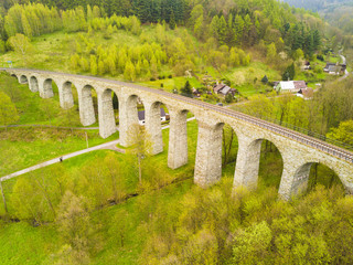 Aerial view of old railway stone viaduct. Tourist attraction in Krystofovo Udoli (Christofsgrund), Novina, Czech republic. Famous historical viaduct in Liberecky kraj, European union.