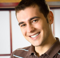 Portrait of happy smiling young man