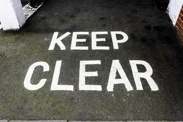 Keep Clear writing on asphalt pavement