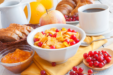 Breakfast with corn flakes, fruit and coffe