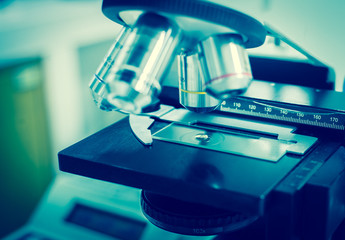 blurred microscope medical equipment in blue tone.