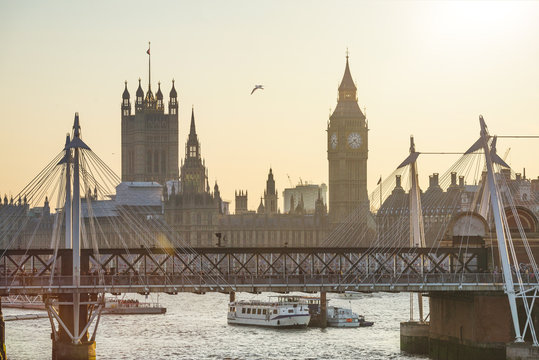 Big Ben and Golden Jubilee Bridges at sunset in London