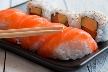 Salmon sushi and roll sushi with chopstisks