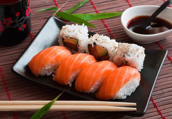 Salmon sushi and roll sushi with soy sauce