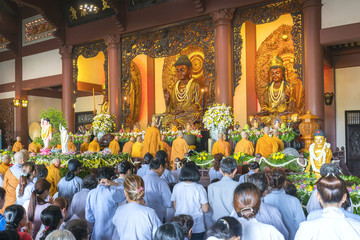 Obraz premium Ho Chi Minh City, Vietnam - May 10th, 2017: Buddhist revered ceremony in temple beautiful architecture, many statues sanctuary express cultural beauty of religious spirituality in Ho Chi Minh, Vietnam