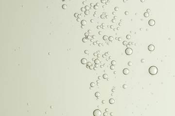 Flowing fizz bubbles, isolated over a light blurred background