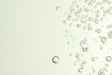 Beautiful champagne bubbles flows over a gray surface © dkidpix