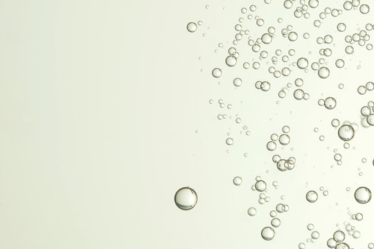 Beautiful champagne bubbles flows over a gray surface