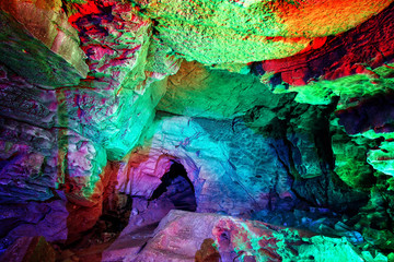 Entrance to ice cave. surrealist underground. The hole in the cave, painted in fantastic colors