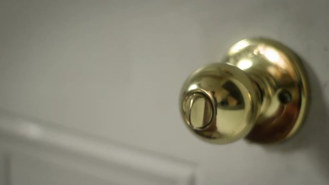Multipurpose clip - Man locks and unlocks his doorknob basic lock