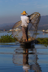 Traditional burmese fisherman on his boat at Inle lake