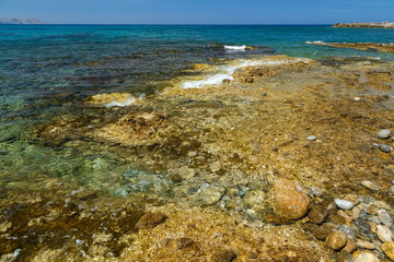 Beach in Crete with rocks and pebbles.