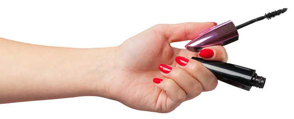 woman hand holding eyelash brush.