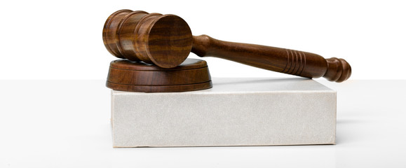 Wooden gavel and books on wooden table