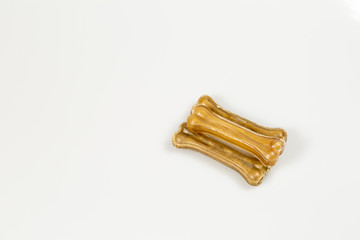 Chewing veal leather bones for dogs on white background, top view