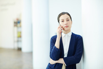 Fototapeta premium Serious businesswoman speaking on mobile phone